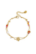 Bracciale con ciondoli a forma di stella e fiore, perle, pietre e perline.